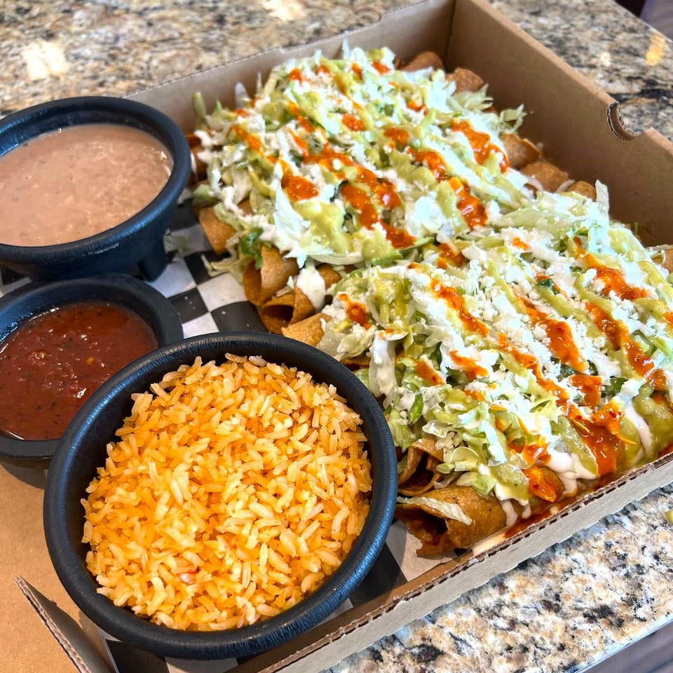 Boss Man Tacos Burritos & More's taquitos with rice, beans, and salsa in a takeout box.